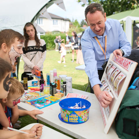 John Bowker playing cards with children at family fun day